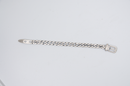 Silver chain belt on a light gray background