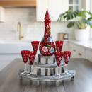 Decorative red glass set with floral patterns on a kitchen counter.