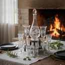 Decorative glassware on a table with a fireplace in the background