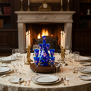 Elegant dining table setting with blue floral glasses in a room with a fireplace and chandelier.