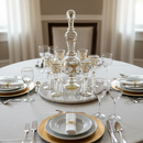 Elegant table setting with glassware and cutlery on a round table.
