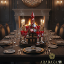 Decorative table setting with red glassware and a central vase in a dimly lit room with a chandelier.