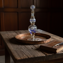 Decorative glass bottle with blue pattern on a wooden table