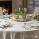Dining table setting with green glassware and a bottle, Arabazaar logo visible.