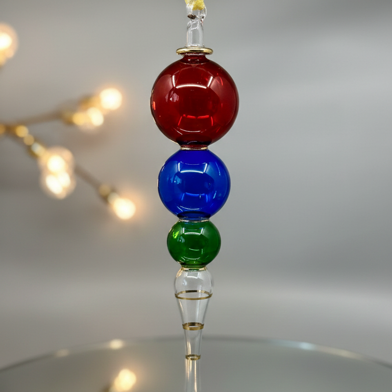 Decorative hanging ornament with red, blue, and green glass beads on a neutral background.