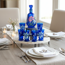 Dining table setting with blue glassware and floral design, featuring the Arabazara brand.