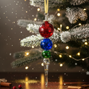 Decorative Christmas ornament with red, blue, and green beads on a tree background
