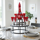 Decorative red vase and glasses on a stand in a dining room setting.