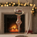 Decorative glass ornament on a stand with a blurred festive background