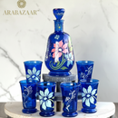 Set of blue glassware with floral designs on a white surface, featuring the Arabazaar brand.
