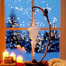 Decorative glass finial with candles and a window view of blurred lights
