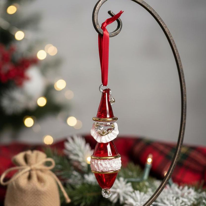 Decorative Christmas ornament with red and white elements hanging against a festive background.